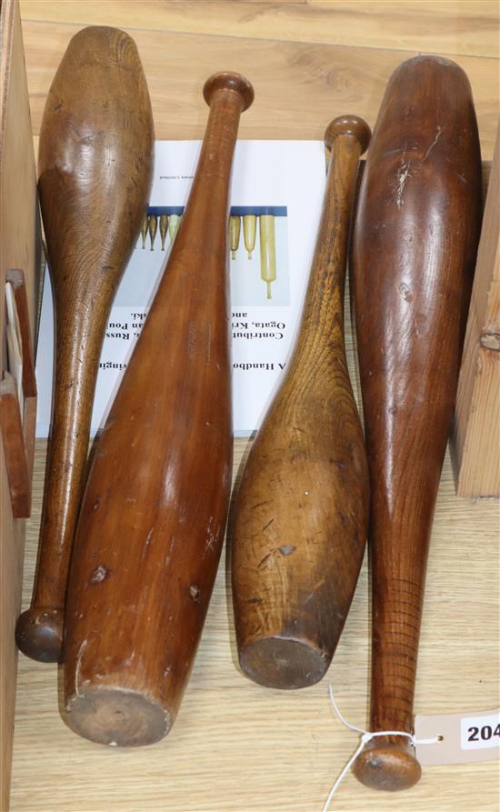 Four hardwood swinging clubs